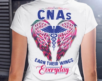 May include: White t-shirt with a design featuring the word "CNAS" in blue, above a pair of pink and red wings with a blue caduceus symbol. The text "EARN THEIR WINGS Everyday" is below the wings.