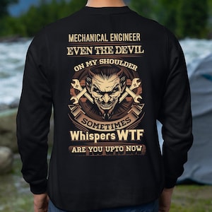 May include: Black sweatshirt with the text "MECHANICAL ENGINEER EVEN THE DEVIL ON MY SHOULDER SOMETIMES Whispers WTF ARE YOU UPTO NOW". The design features a devil face with crossed wrenches.