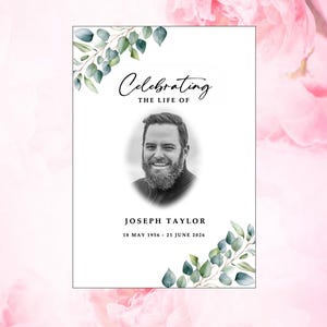 May include: A memorial card featuring a portrait of Joseph Taylor, adorned with eucalyptus leaves. The text reads "Celebrating the Life of" above the name and dates: 18 May 1956 - 21 June 2026. The background is a soft pink floral design.