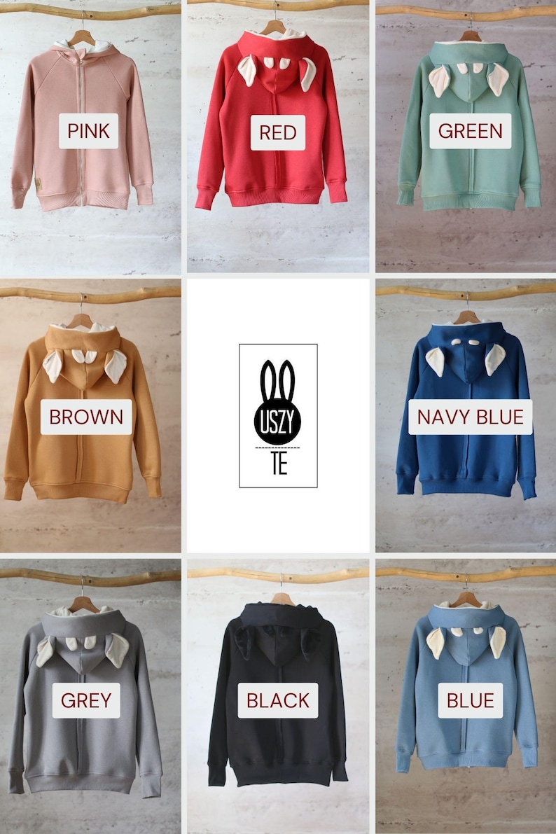K&ouml;nnte beinhalten: Neun Kapuzenpullover in verschiedenen Farben mit Hasenohren an der Kapuze. Die Farben sind rosa, rot, gr&uuml;n, braun, marineblau, grau, schwarz und blau. Der Text "USZY TE" befindet sich in der Mitte des Bildes.