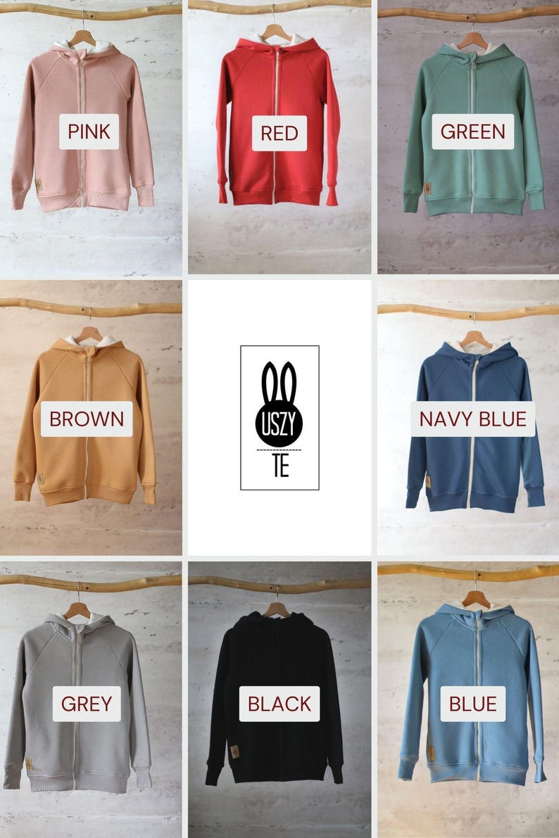 K&ouml;nnte beinhalten: Neun Kapuzenpullover in verschiedenen Farben, jeder mit einem Rei&szlig;verschluss. Die Farben sind rosa, rot, gr&uuml;n, braun, marineblau, grau, schwarz und blau. Die Pullover haben eine wei&szlig;e Umrandung an der Kapuze. Das Logo "USZY TE" ist in der Mitte des Bildes sichtbar.