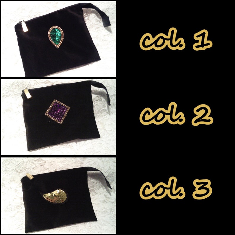May include: Three black velvet pouches with different colored embellishments. The first pouch has a green teardrop-shaped embellishment. The second pouch has a purple square-shaped embellishment. The third pouch has a gold teardrop-shaped embellishment.