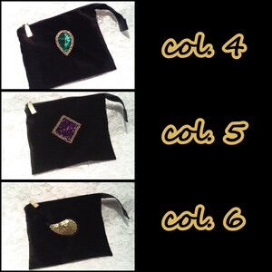May include: Three black velvet pouches with different colored sequins. The first pouch has a green teardrop-shaped sequin, the second pouch has a purple square sequin, and the third pouch has a gold paisley-shaped sequin. The pouches are labeled "col. 4", "col. 5", and "col. 6".