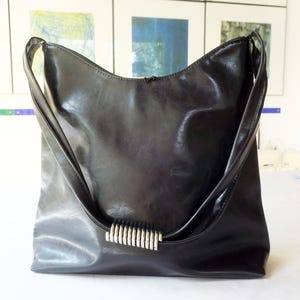 Vintage shoulder bag made of black sturdy leather