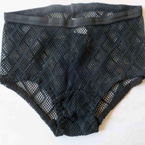May include: Black mesh underwear with an elastic waistband. The underwear has a high-waisted design and a diamond-patterned mesh. The garment is made of a sheer, lightweight material.