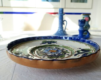 Vintage ceramic plate with a higher rim bowl painted with farmer's painting