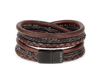 May include: A brown leather bracelet with a black braided leather strap and a black metal clasp. The clasp has the word "INNOVA" engraved on it.