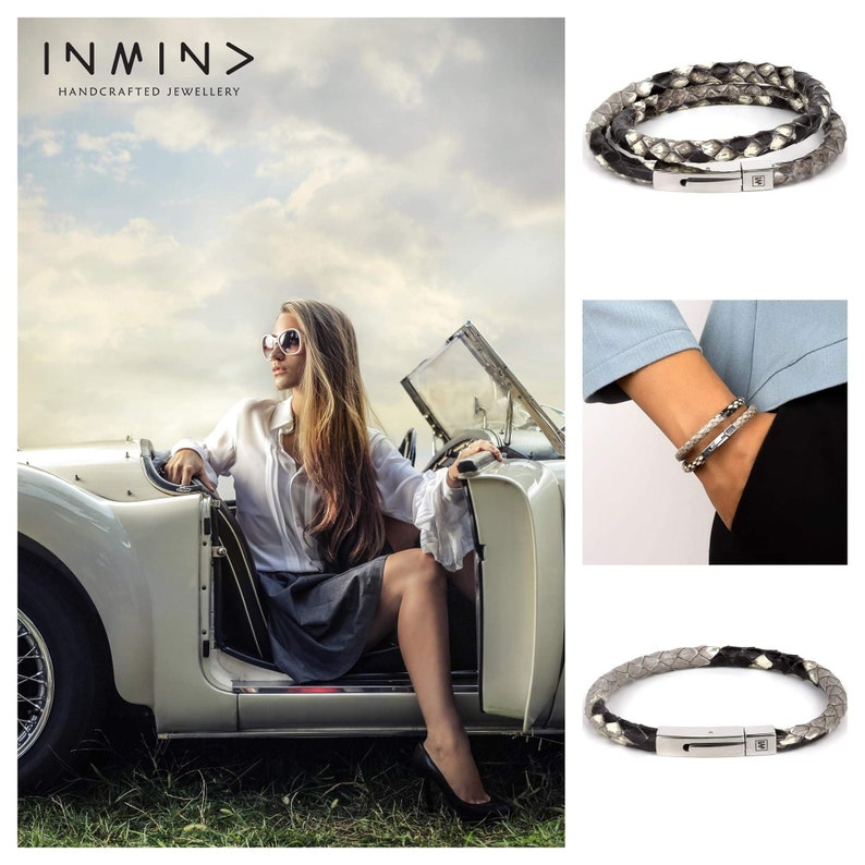 May include: Two leather bracelets with a silver clasp. The bracelets are made of braided leather in black and grey. The bracelets are shown on a model's wrist and on a white background.