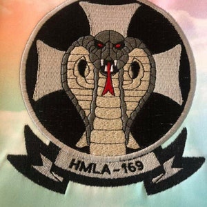 Custom embroidery digitizing service example – company logo stitched on whtie fabric.