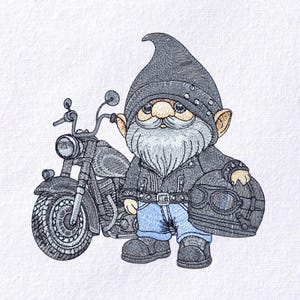 May include: Embroidered image of a biker gnome with a gray beard, wearing a black leather jacket, jeans, and boots. The gnome is holding a helmet and standing next to a motorcycle. The image is on a white background.