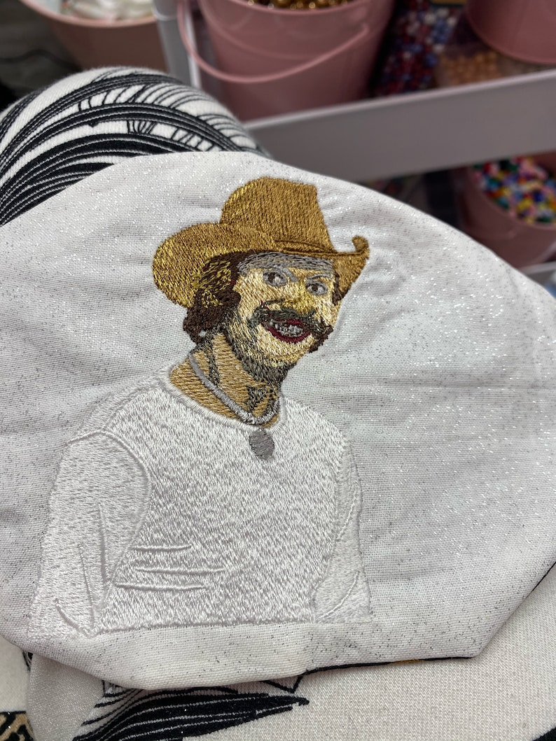 Stitched result of a custom artwork of a southern man digitized for embroidery, showing fine detail and vibrant color accuracy.