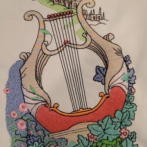 Custom logo digitized into embroidery stitch file and stitched on fabric sample.