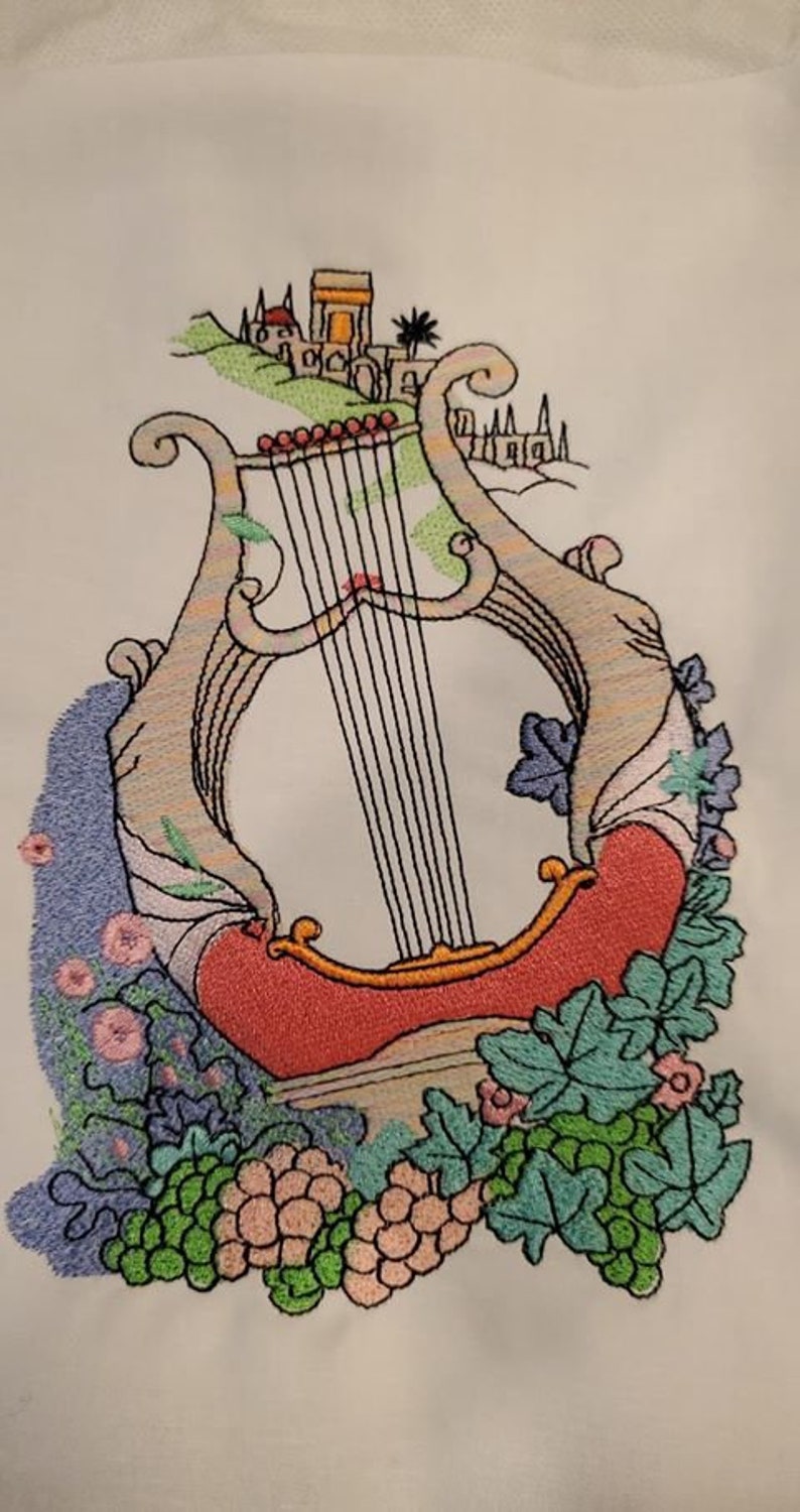 Custom logo digitized into embroidery stitch file and stitched on fabric sample.