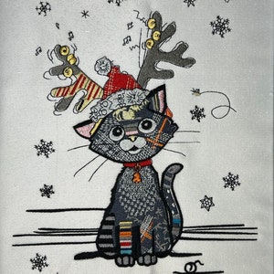 May include: A black cat wearing a red Santa hat with reindeer antlers and jingle bells. The cat is sitting on a white background with snowflakes.