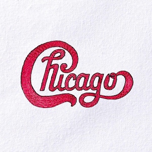 May include: Red embroidered text on a white background reads "Chicago" in a cursive, stylized font. The letters are connected and have a textured appearance, suggesting an embroidered design. The overall aesthetic is vintage.