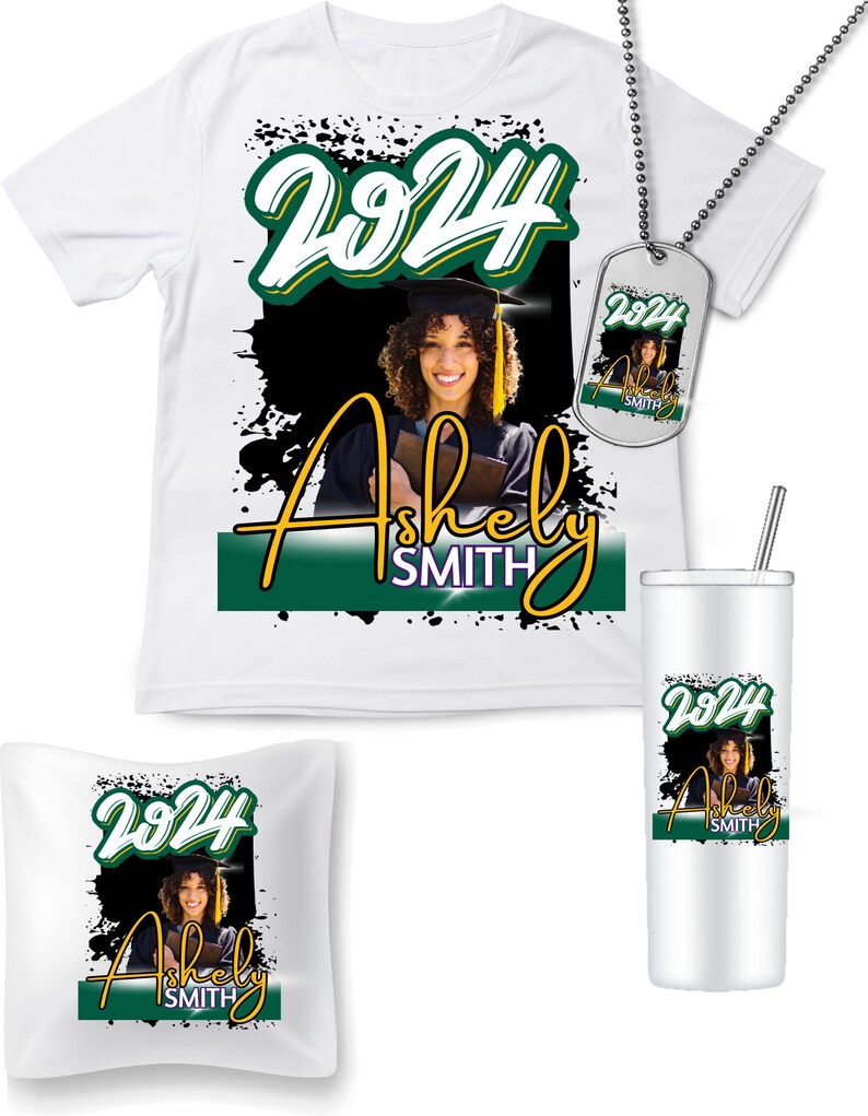 May include: A collection of graduation-themed items featuring a smiling graduate. Includes a white t-shirt, dog tag, pillow, and tumbler. Each item displays the year "2024" and the name "Ashely Smith" in a green and gold design against a black background.