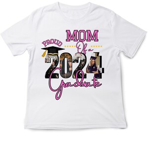 May include: White t-shirt with the text "PROUD MOM Of a 2024 Graduate" in pink and black. The number "2024" is filled with images of graduates. A black graduation cap with a gold tassel is also featured.