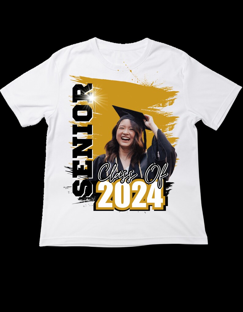 May include: White t-shirt featuring a graduation theme. The shirt has the word "SENIOR" printed vertically in black and white, with "Class Of 2024" in gold and white. A photo of a smiling graduate in a cap and gown is in the center.