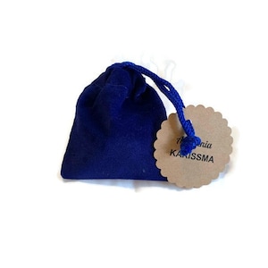 May include: A small blue velvet bag with a brown tag that says "Alchemia Karissma".