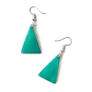 May include: A pair of teal triangle shaped earrings with silver hooks.