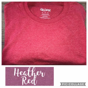 May include: A red heather Gildan t-shirt. The tag is visible and says "Gildan" in white letters.