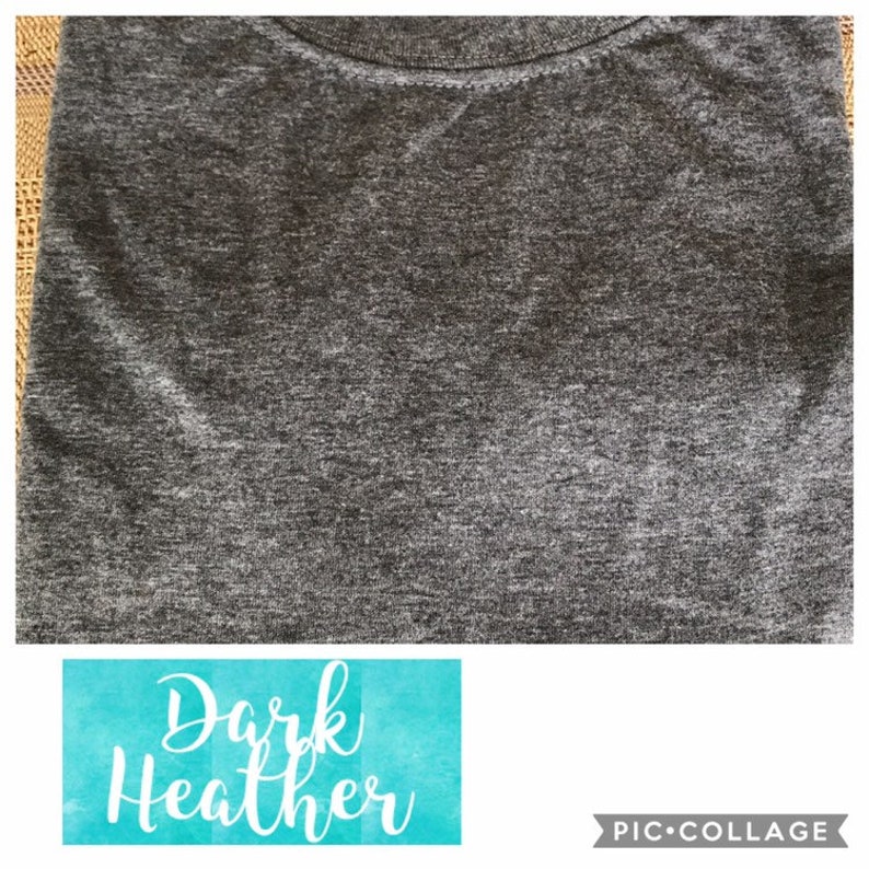 May include: A close-up of a dark heather grey t-shirt. The fabric has a textured, slightly speckled appearance.