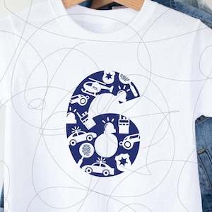 May include: White t-shirt featuring a large navy blue number six filled with police-themed illustrations. The design includes police cars, a helicopter, a badge, and a siren. The shirt is displayed on a wooden hanger.