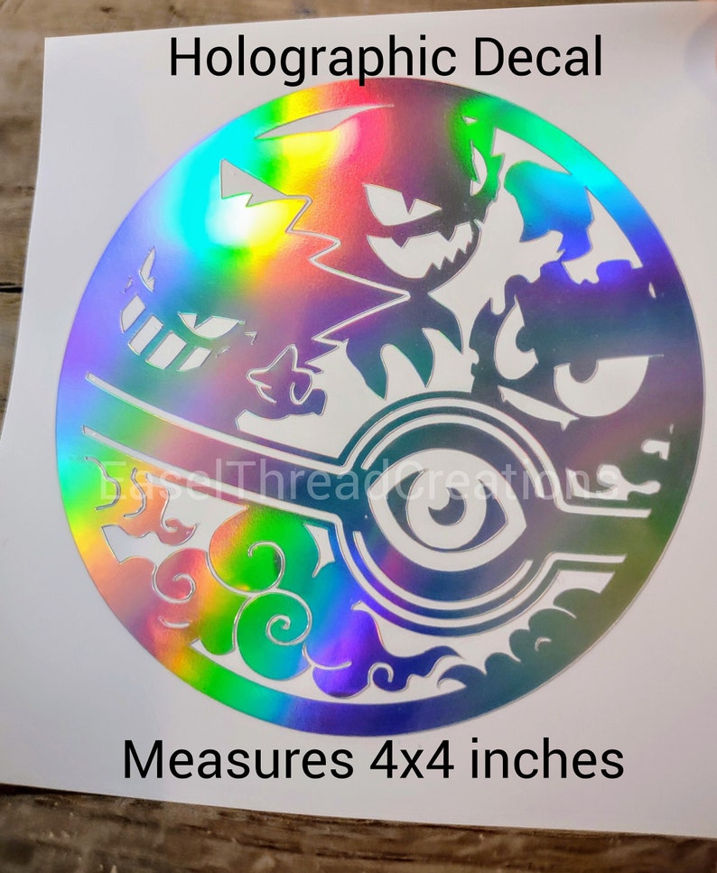 May include: A holographic decal featuring a circular design with a white eye and clouds in the bottom half. The top half features a silhouette of a Pokemon character. The decal measures 4x4 inches. "Holographic Decal" and "Measures 4x4 inches" are printed in black text on a white background.