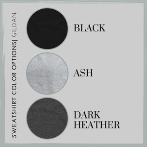 May include: Three color swatches for a Gildan sweatshirt. The swatches are black, ash, and dark heather.