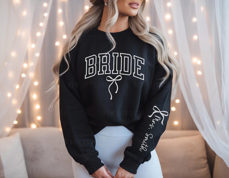 Black Bride Sweatshirt with white Bow and the Custom Mrs. Last Name on sleeve. Perfect for an engagement.