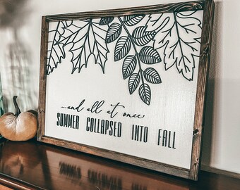 Puede incluir: Un letrero de madera con una silueta negra de hojas y el texto "...and all at once SUMMER COLLAPSED INTO FALL".