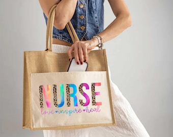May include: A brown jute tote bag with a white canvas pocket. The pocket features a rainbow and leopard print design with the word "NURSE" and the text "love inspire heal".