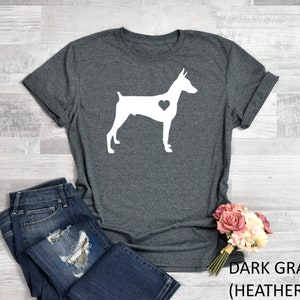 May include: Dark gray heather t-shirt with a white silhouette of a Doberman Pinscher with a heart on its chest.