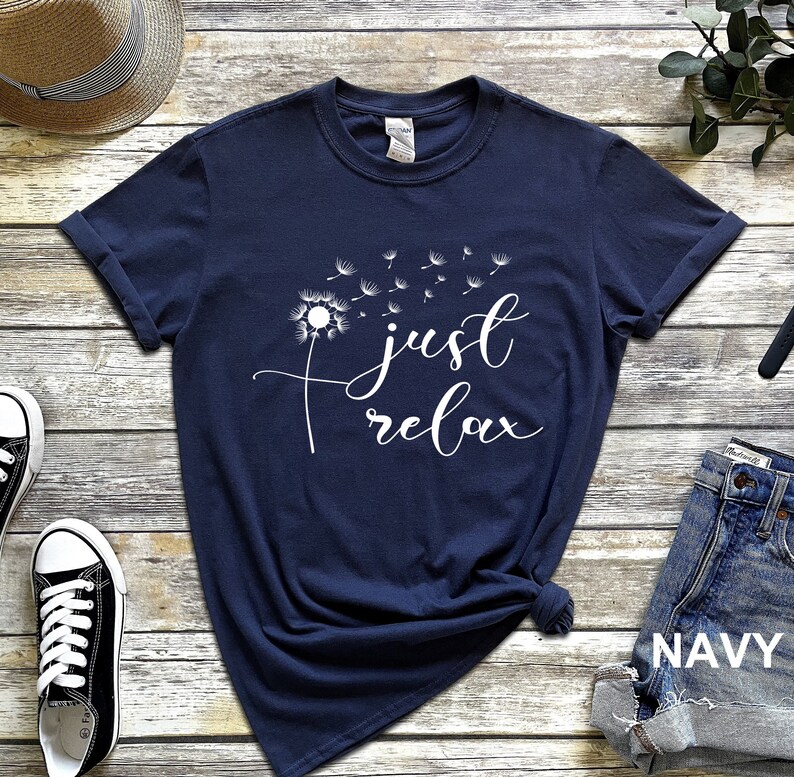 May include: Navy blue t-shirt with a white dandelion graphic and the text "just relax".