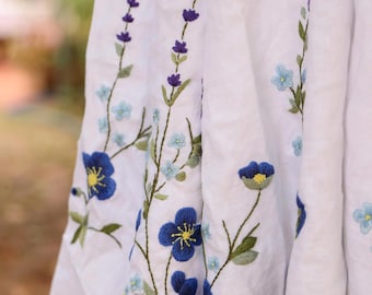 Vestido de novia azul de lino bordado con flores, vestido de novia de corte A con mangas abullonadas, vestido de novia de estilo cottagecore para bodas en jardines.