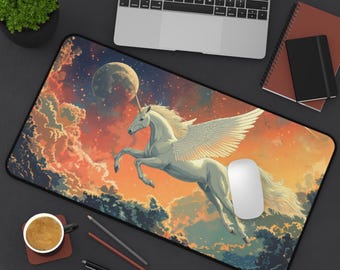 May include: A rectangular mouse mat with a white winged unicorn against a backdrop of a colorful sky with clouds, a moon, and stars. The background has orange, red, and blue hues. A laptop, coffee cup, and pens are also visible.