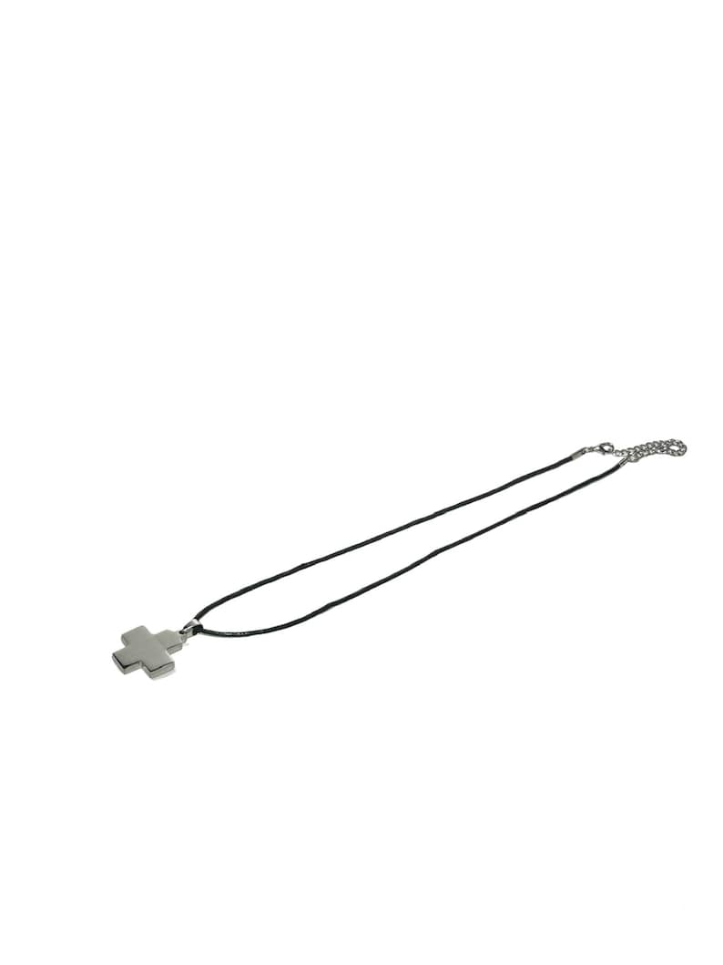 May include: A silver cross pendant on a black cord necklace.