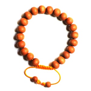 May include: A brown wooden beaded bracelet with a yellow string closure.