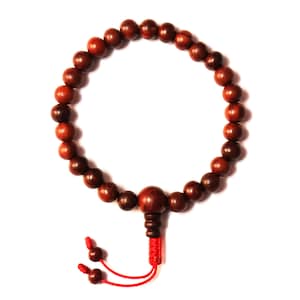May include: A brown wooden mala bead bracelet with a red string tassel.
