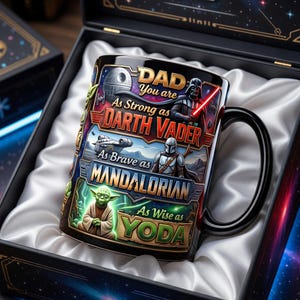May include: A black ceramic mug with a Star Wars theme, featuring Darth Vader, the Mandalorian, and Yoda. The mug has the text "DAD You are As Strong as Darth Vader, As Brave as Mandalorian, As Wise as Yoda." The mug is presented in a decorative box.