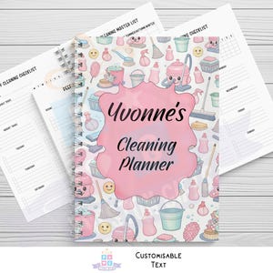 May include: A spiral-bound cleaning planner with a pink cover featuring cleaning supplies illustrations. The cover reads "Yvonne's Cleaning Planner" in black script. Includes weekly and daily checklists. The background is a light wood grain.