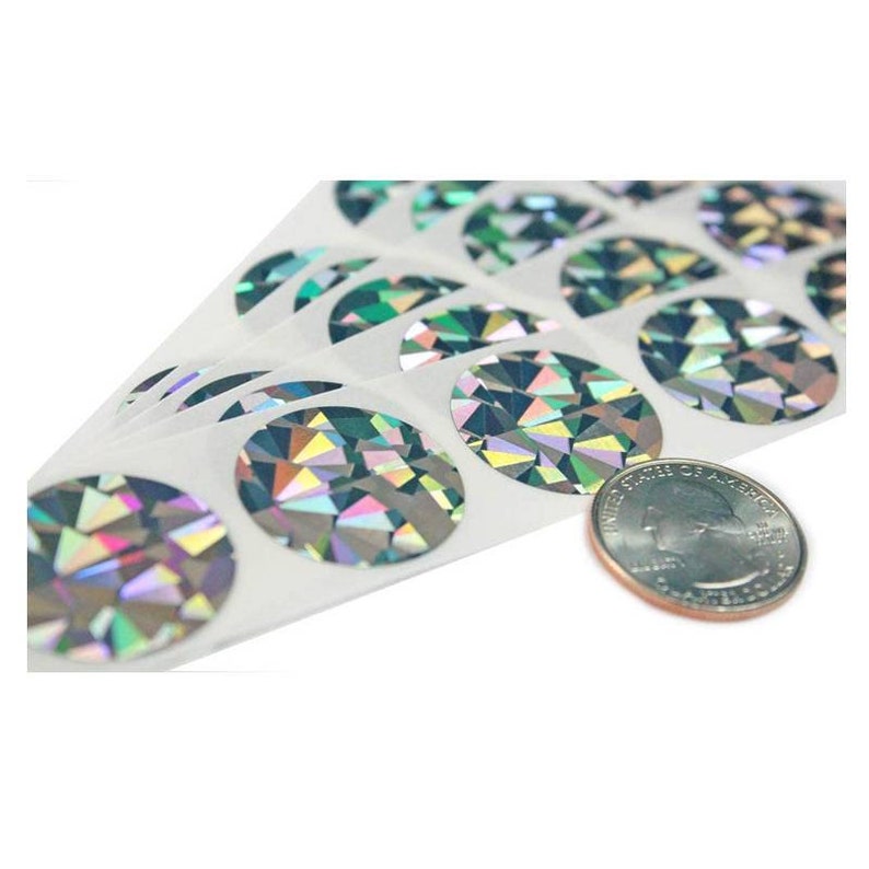 May include: A sheet of round, iridescent holographic stickers. The stickers are about the size of a US quarter.