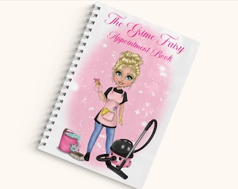 Puede incluir: Un libro de citas con encuadernación en espiral y cubierta blanca con el texto The Grime Fairy Appointment Book en rosa. La ilustración muestra a un personaje rubio con delantal rosa sosteniendo un pulverizador, un cubo rosa y una aspiradora.