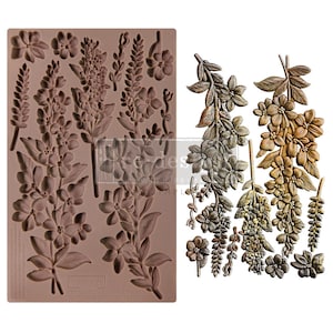 Peut inclure: Un moule en silicone avec un motif floral. Le moule est brun et présente une variété de fleurs et de feuilles. Le moule est présenté à côté d'un produit fini, qui est un ensemble d'embellissements floraux bruns.