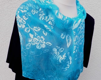 An extraordinary scarf, burnout fabric, painted with French colors in turquoise with a bright shimmering pattern.