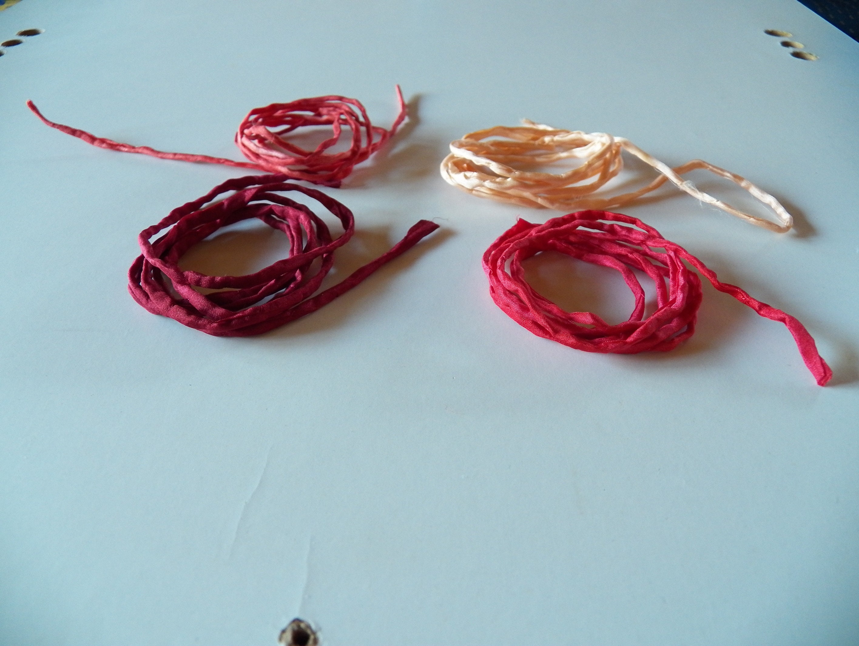 Silk cords, silk ribbons, 100 % silk, hand-dyed shades of red, approx. 1 m