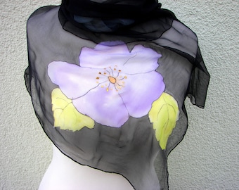 A gossamer silk chiffon cloth painted with French colors, background black with painted flowers in red, blue and lilac.