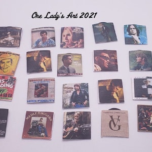 May include: A collection of 18 vintage record album covers featuring various artists, including Otis Redding, George Jones, Merle Haggard, and others. The covers are in various colours and feature different designs.