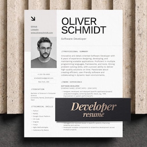 May include: A professional software developer CV template featuring a black and white layout with a headshot, contact details, professional summary, work experience, education, and technical skills sections, with the text Developer resume.