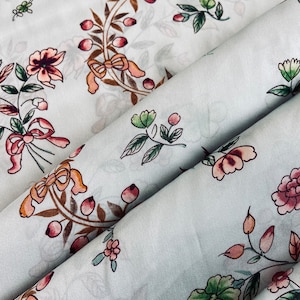 Fine pure silk fabric floral pattern on a greenish background, Natural Italian Silk, premium designer high quality fabric for dress, blouse